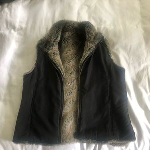 Reversible women’s vest. Faux fur on side, black poly mix other side. Medium